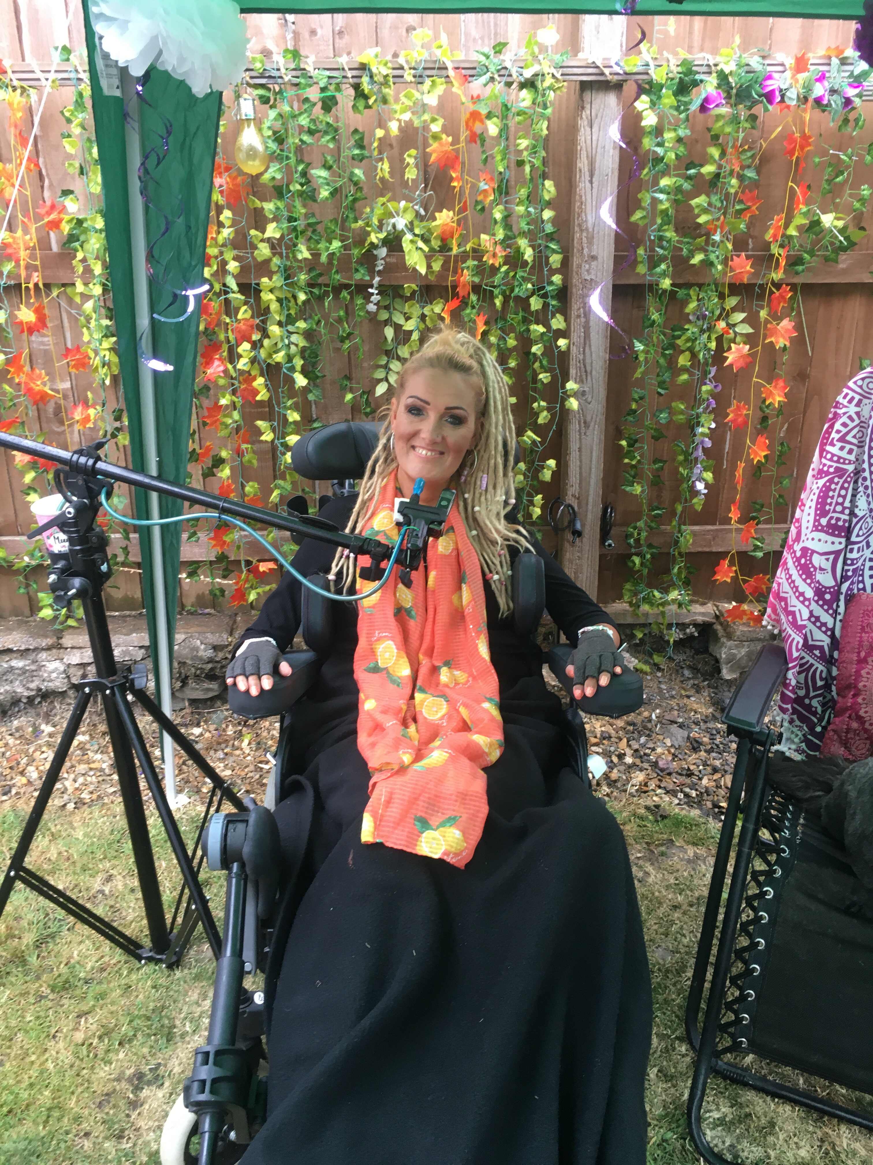 Alyson in the garden in her electric wheelchair