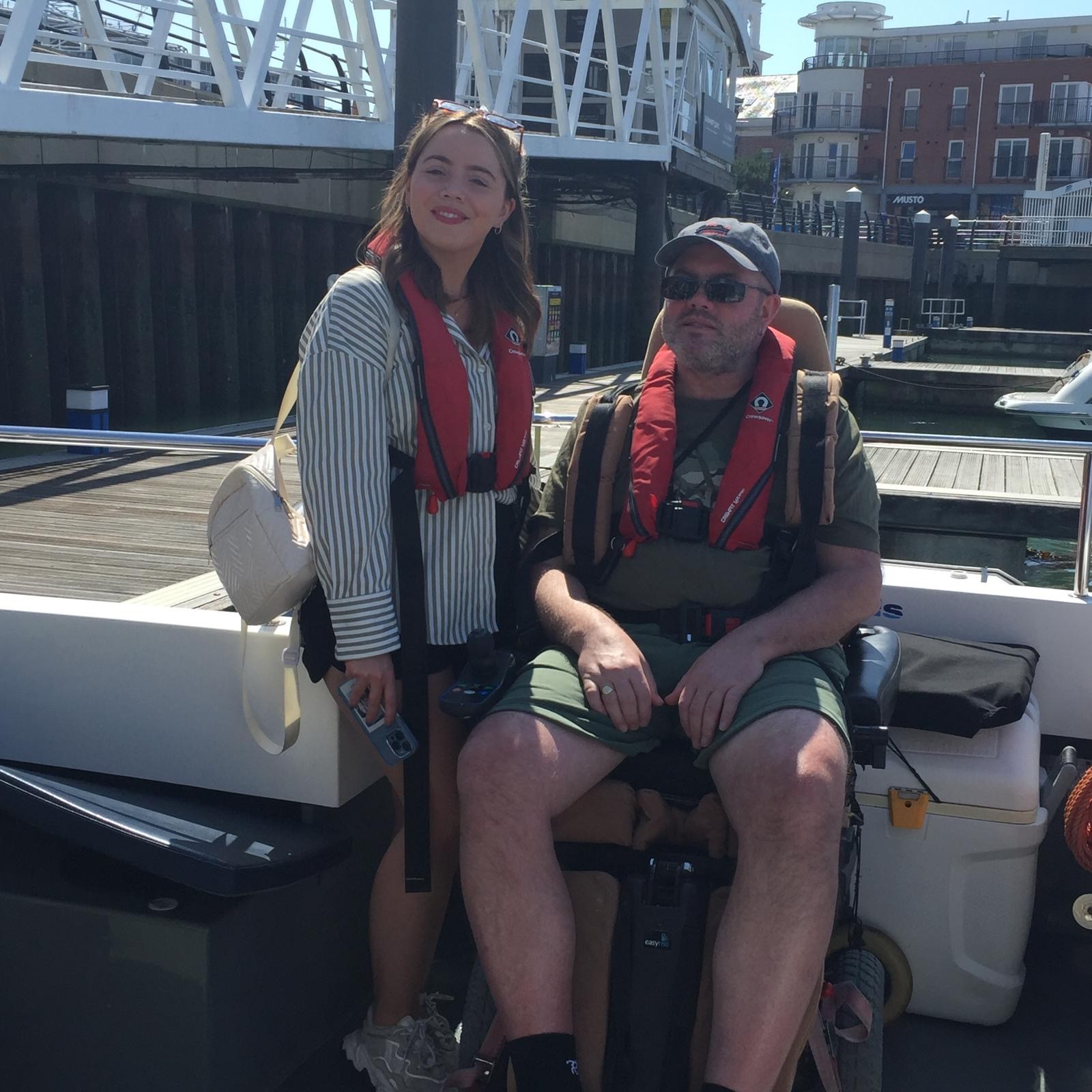 MND Association volunteers on a boat with life-jackets.