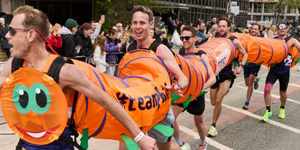 People running in a caterpillar costume at a fundraising event