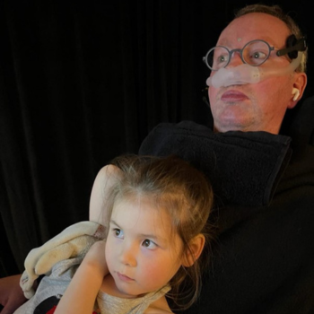 Eoin with his daughter, Roisin, looking at his eye-gaze computer