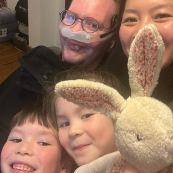 Eoin and his family smiling and taking a selfie. With a toy bunny too!