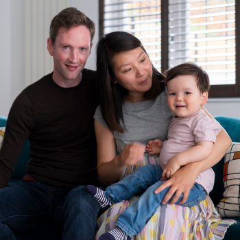 Eoin, Jenny and their son, Liam. They are sitting on a sofa