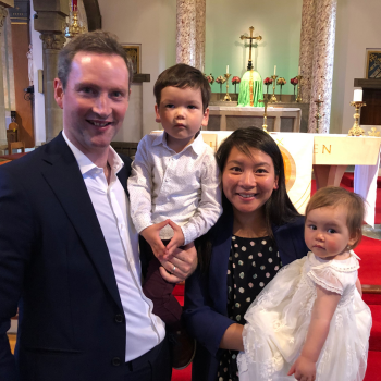 Eoin with his family, in a church at his daughter's christening