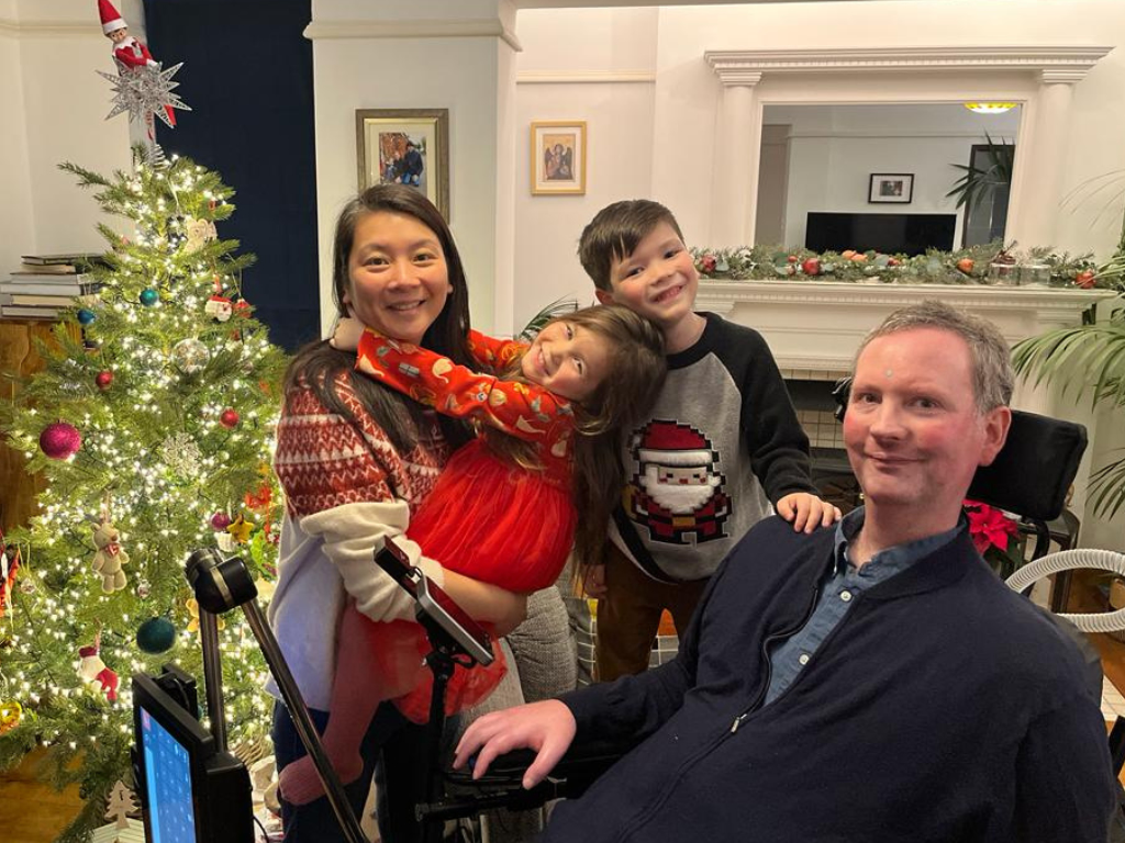 Eoin and his family on Christmas day, in front of the Christmas tree.