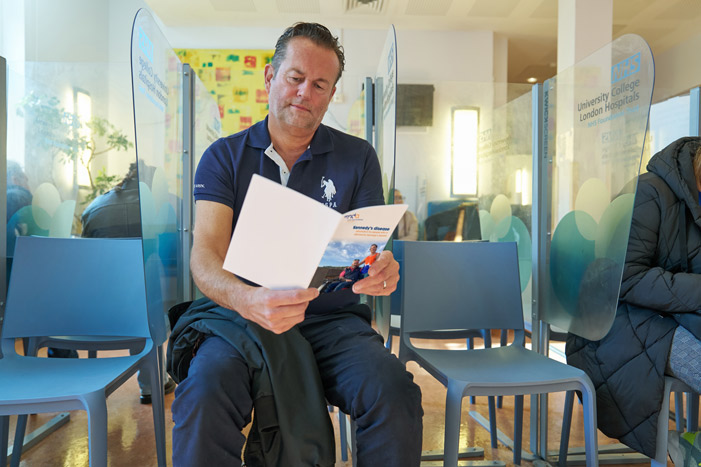 Man reading Kennedy's disease booklet