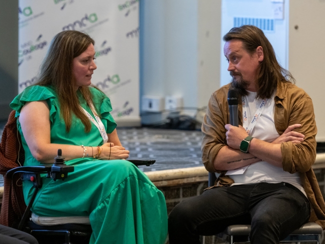 Anna and Martyn sitting in front of the stage, speaking at the EnCouRage event.